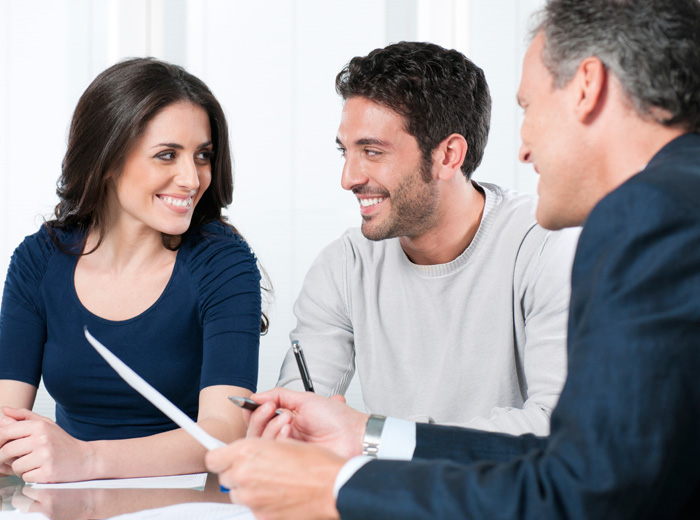 smiling couple in planning meeting with officiant